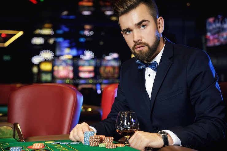 Dealer opening the transparent Sic Bo shaker revealing three dice